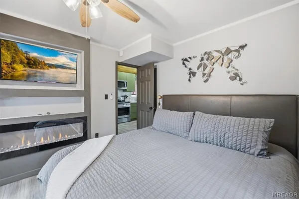 a bedroom with a bed and a chandelier