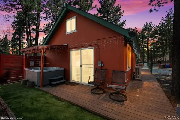 a view of a house with backyard tub and sitting area