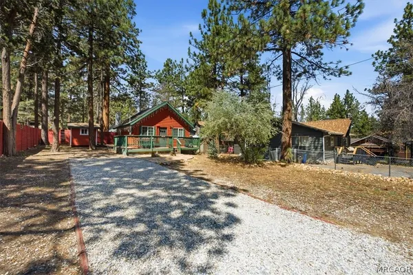 a view of house with outdoor space and trees