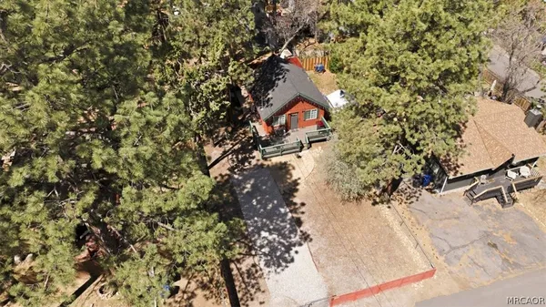 an aerial view of house with yard and mountain view in back
