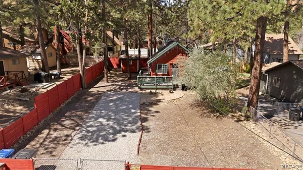 a balcony with wooden floor and outdoor seating