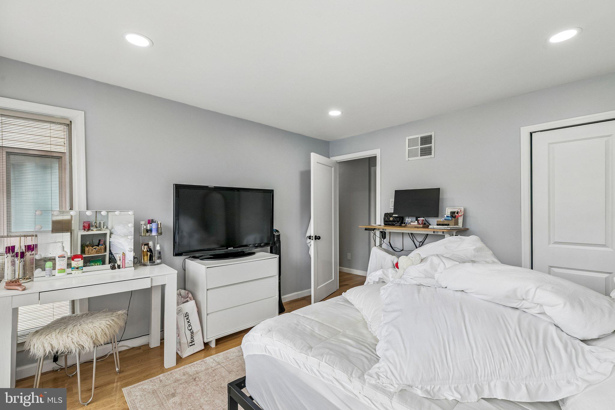 1130 Lombard Street Philadelphia, PA 19147 - Photo 25 of 45 a bedroom with a bed and a flat screen tv