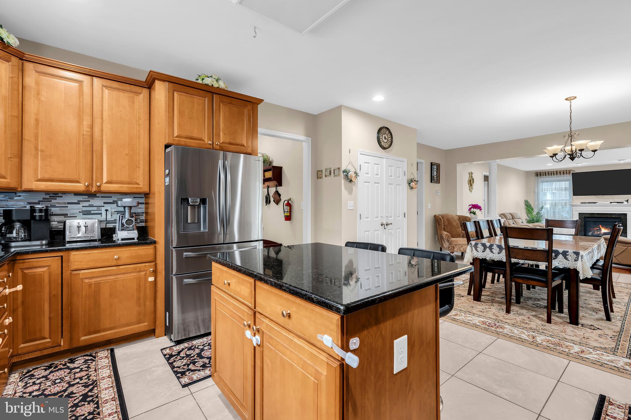 20 Jockey Place Chesterfield, NJ 08515 - Photo 21 of 49 a kitchen with stainless steel appliances granite countertop a refrigerator a sink dishwasher a dining table and chairs with wooden floor