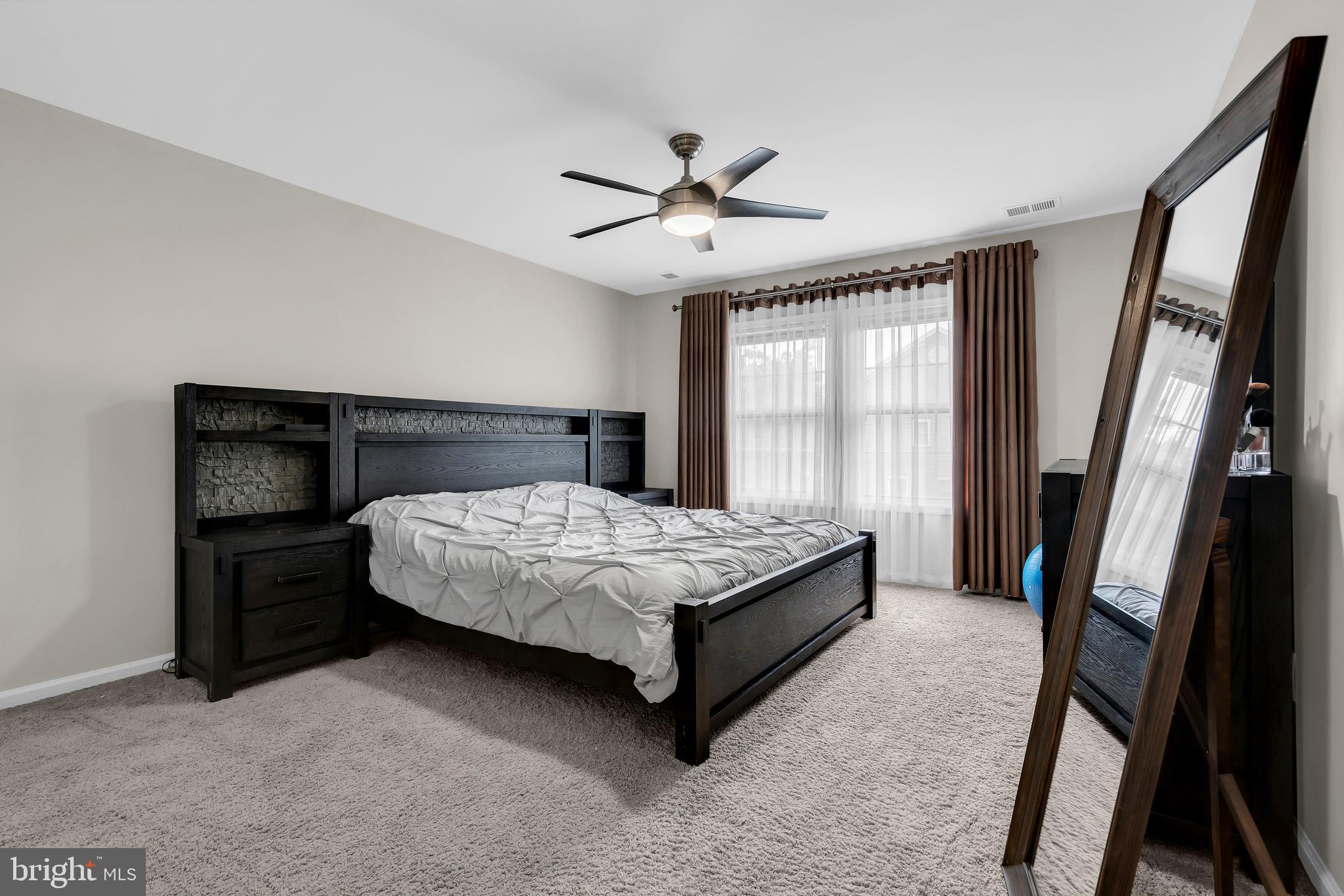 20 Jockey Place Chesterfield, NJ 08515 - Photo 31 of 49 a bedroom with a bed lamp and a large window