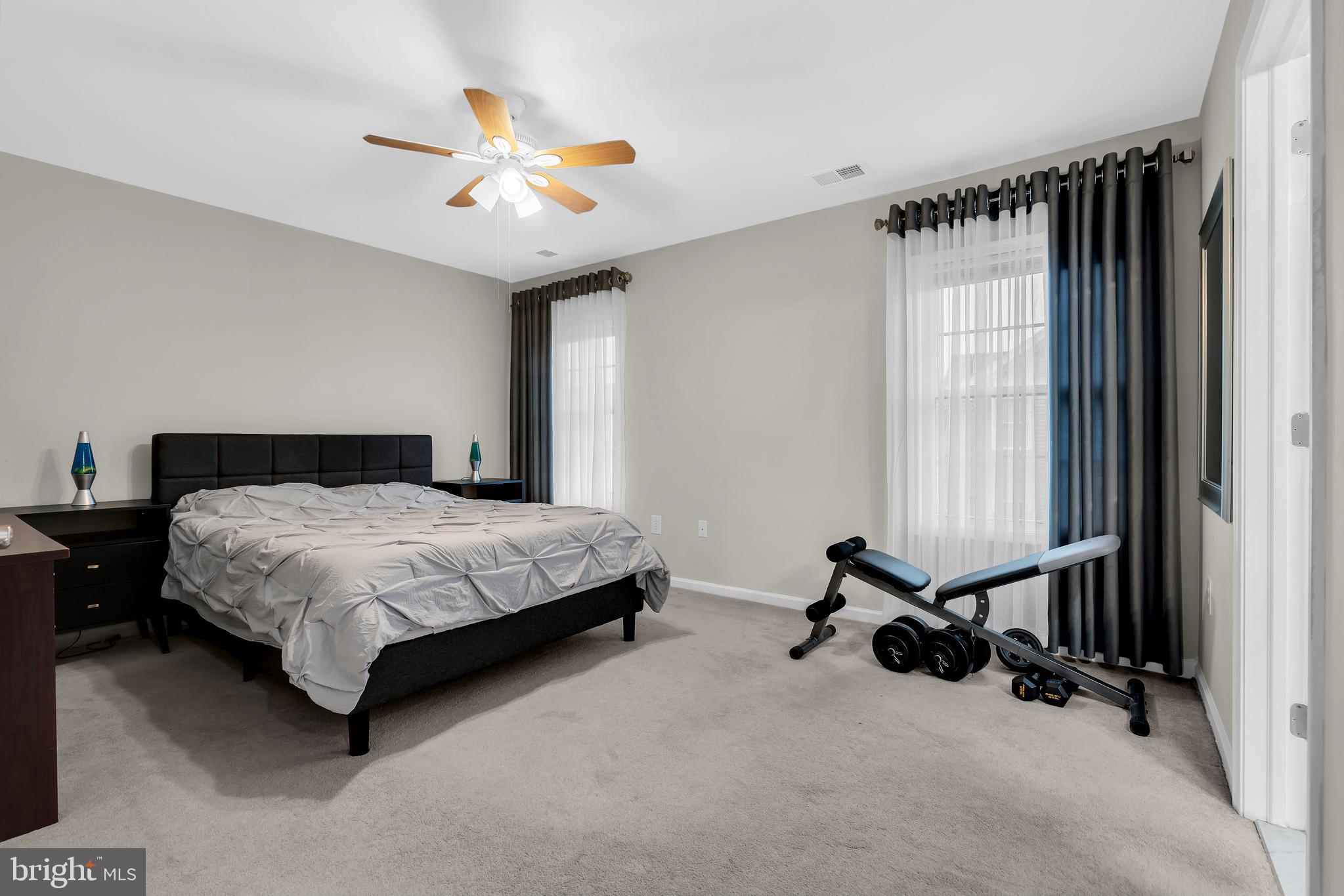 20 Jockey Place Chesterfield, NJ 08515 - Photo 34 of 49 a bedroom with a bed a window and a ceiling fan