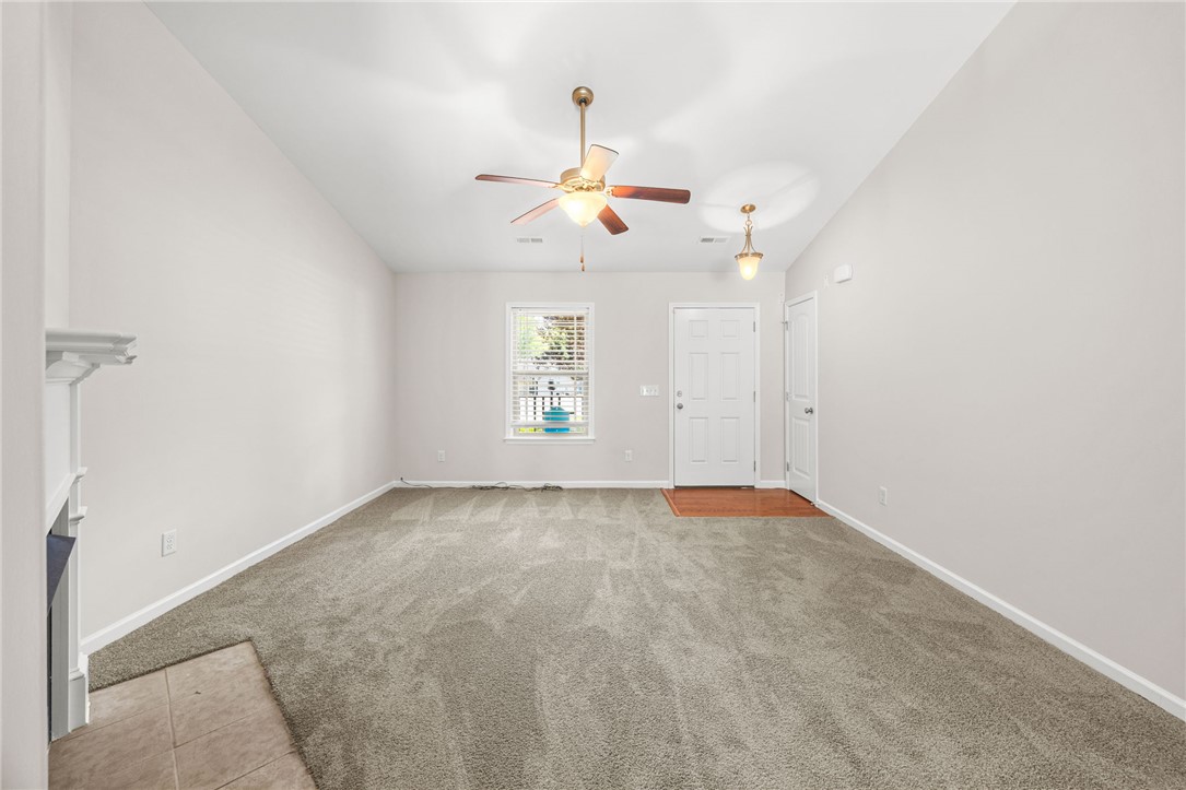 113 Crofton Court Easley, SC 29642 - Photo 5 of 33 This inviting living space features an elegant fireplace and a ceiling fan for comfort.