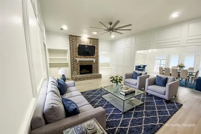 a living room with furniture ceiling fan and a rug