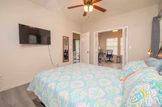 a bedroom with a bed and a flat screen tv