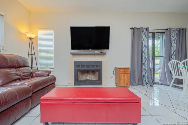 a living room with furniture fireplace and flat screen tv