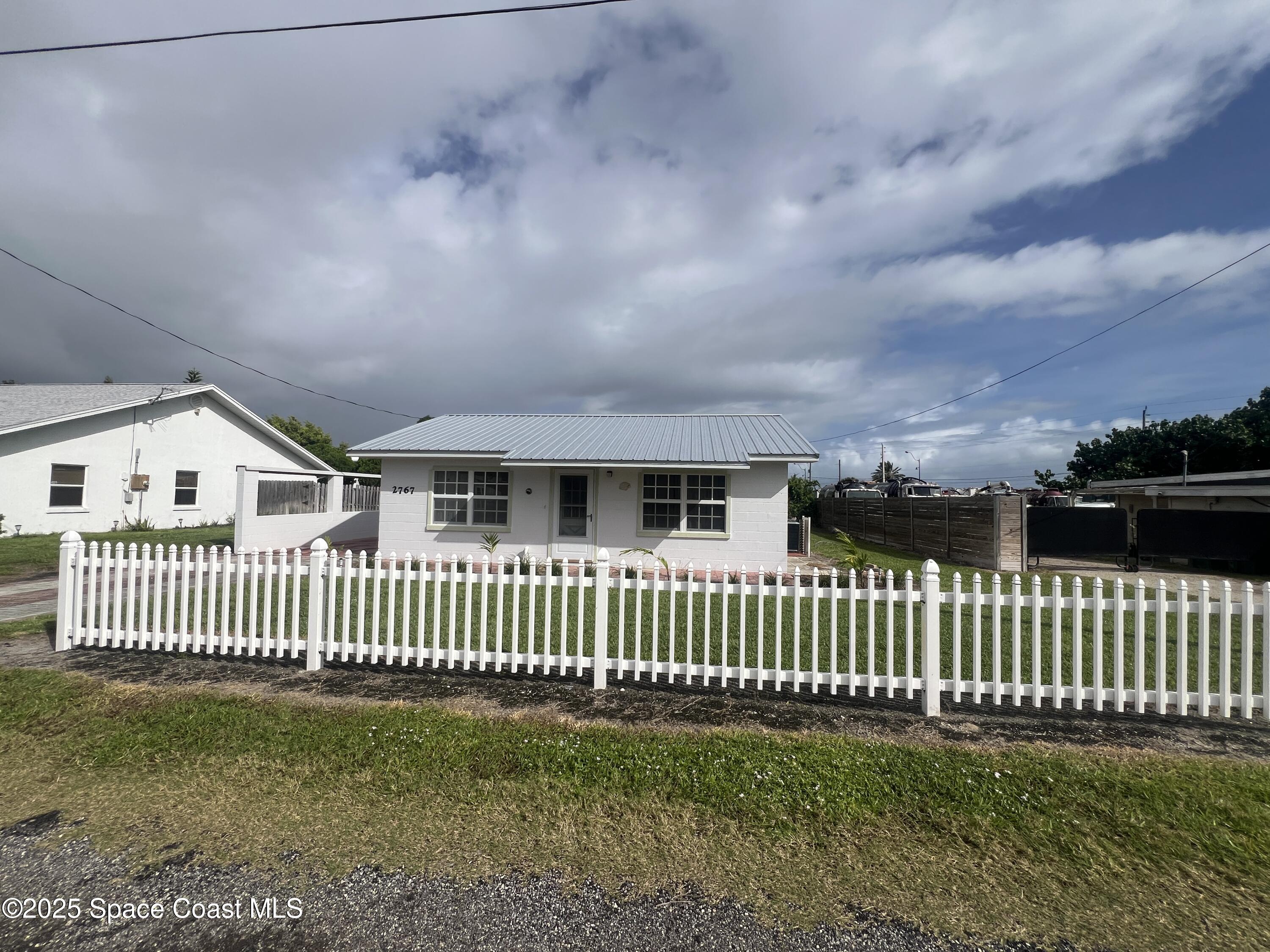 2767 Palm Drive Palm Bay, FL 32905 - Photo 1 of 26 a view of a house with a yard