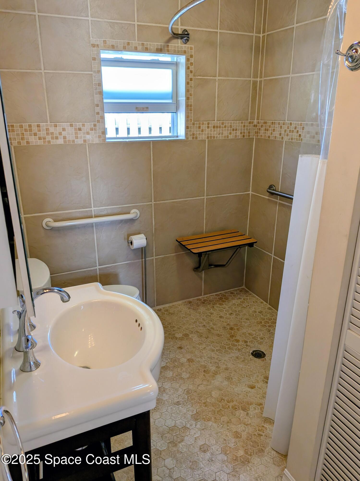 2767 Palm Drive Palm Bay, FL 32905 - Photo 14 of 26 a bathroom with a sink and a toilet