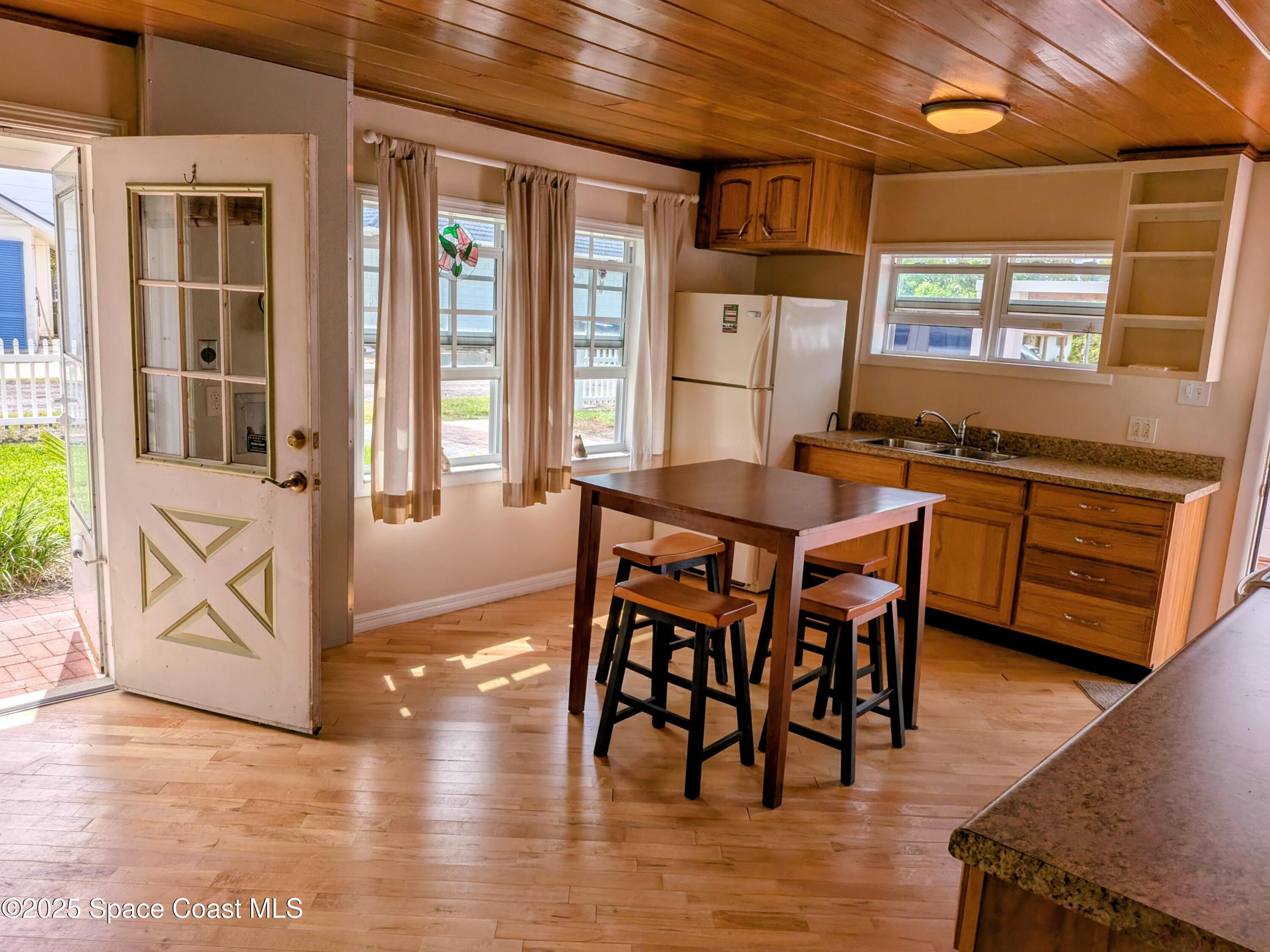 2767 Palm Drive Palm Bay, FL 32905 - Photo 4 of 26 a view of a dining room with furniture window and wooden floor