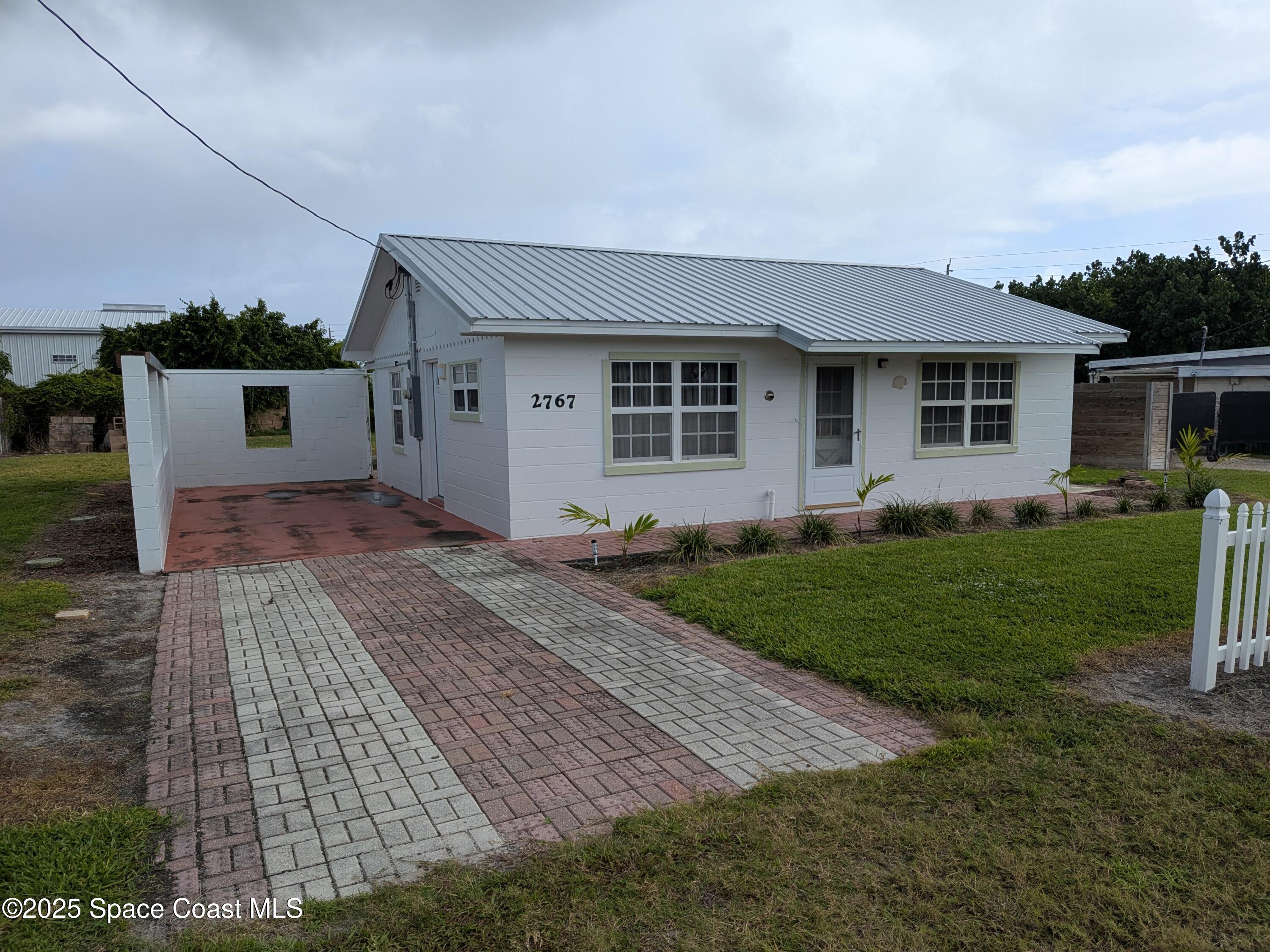 2767 Palm Drive Palm Bay, FL 32905 - Photo 9 of 26 a front view of house with yard and green space