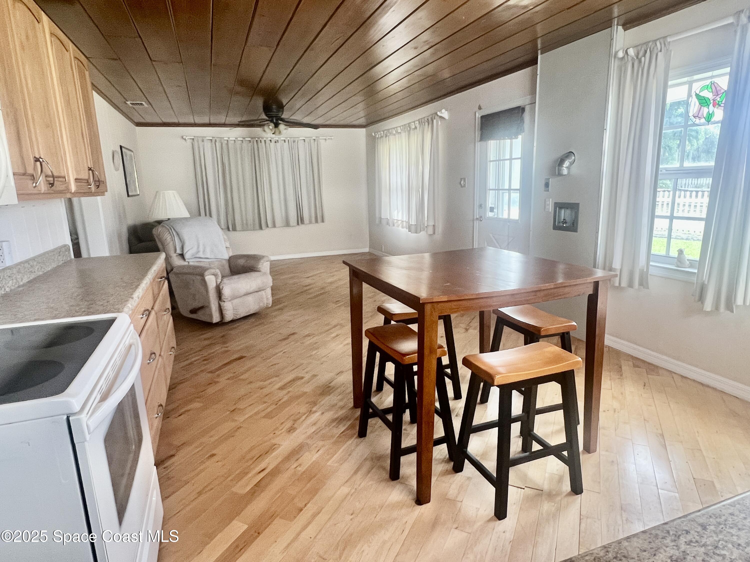2767 Palm Drive Palm Bay, FL 32905 - Photo 10 of 26 a dining room with furniture and wooden floor