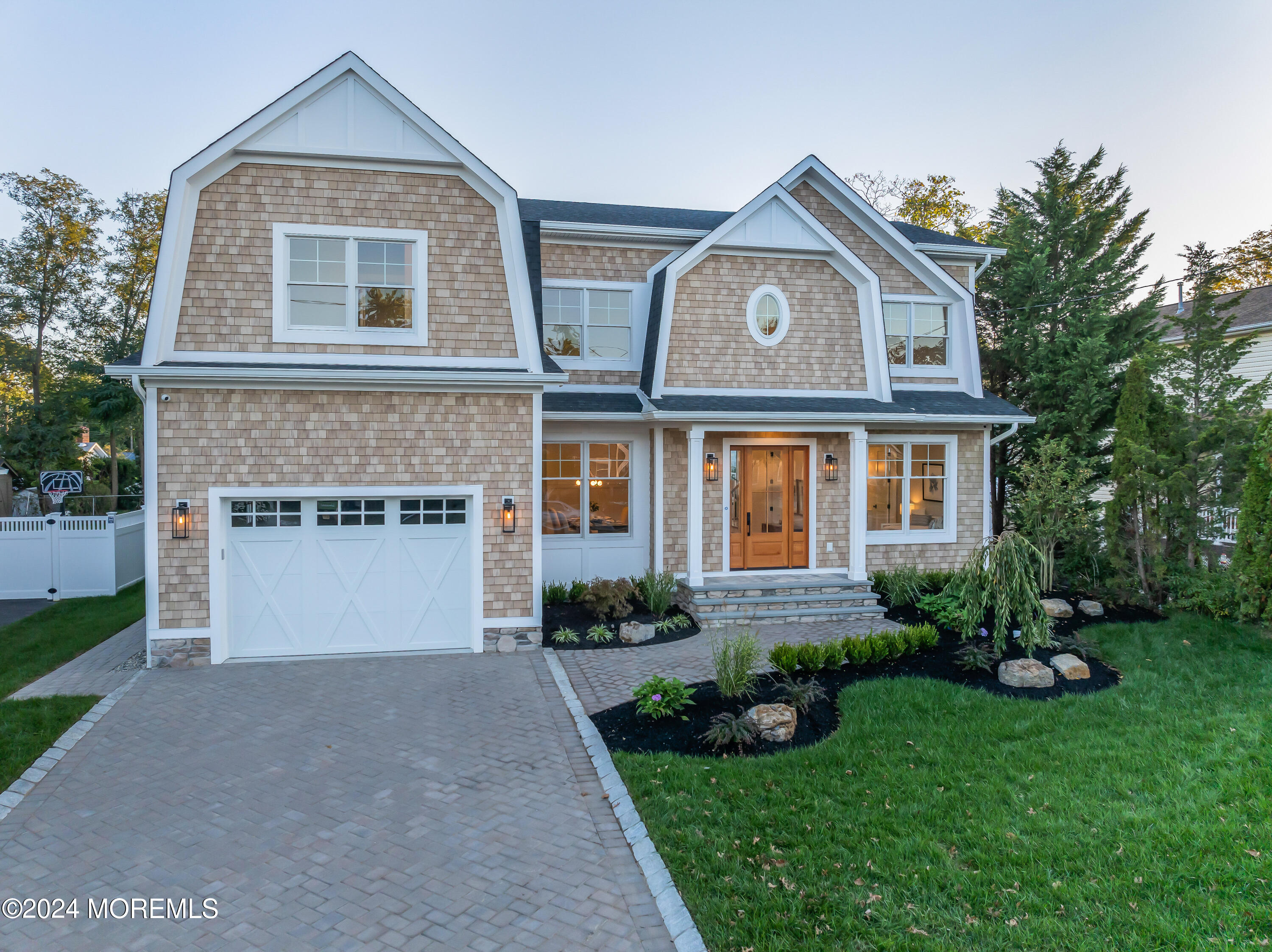 557 Ocean Road Spring Lake Heights, NJ 07762 - Photo 1 of 62 a front view of a house with a garden and plants