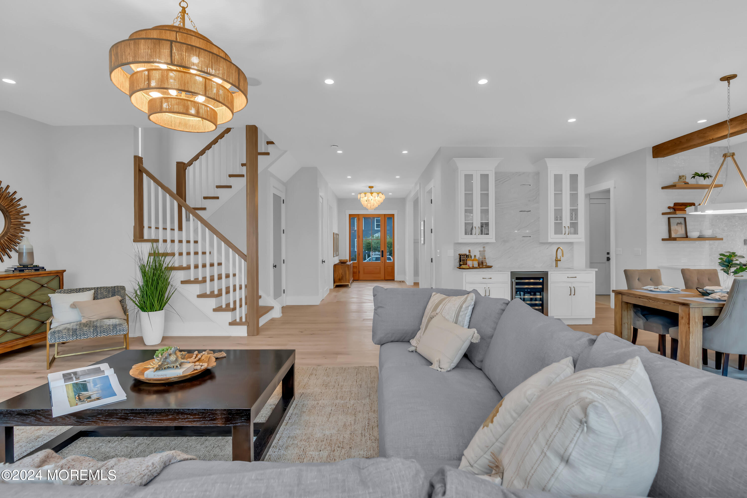 557 Ocean Road Spring Lake Heights, NJ 07762 - Photo 11 of 62 a living room with furniture and a chandelier