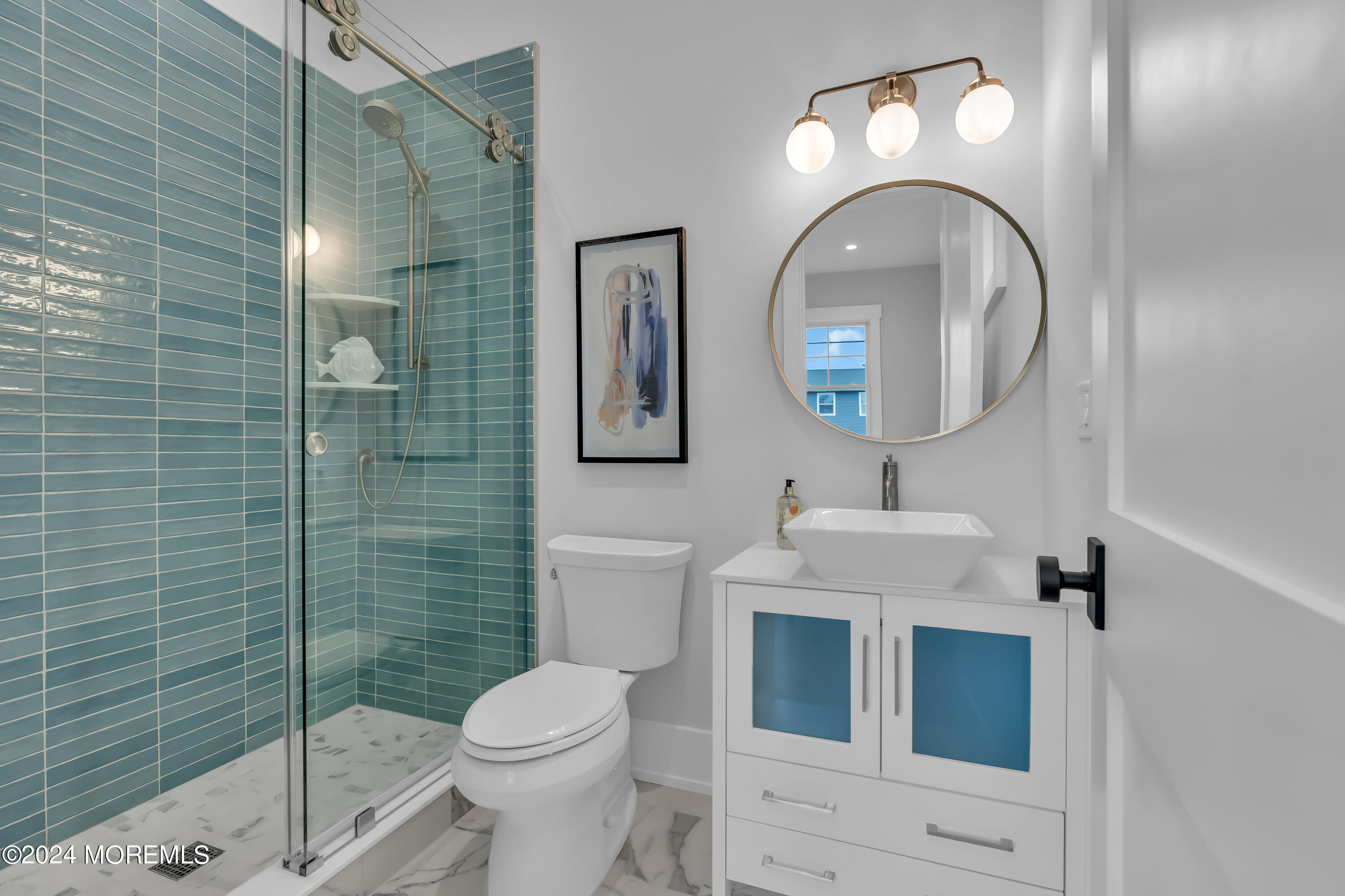 557 Ocean Road Spring Lake Heights, NJ 07762 - Photo 27 of 62 a bathroom with a toilet sink vanity and mirror