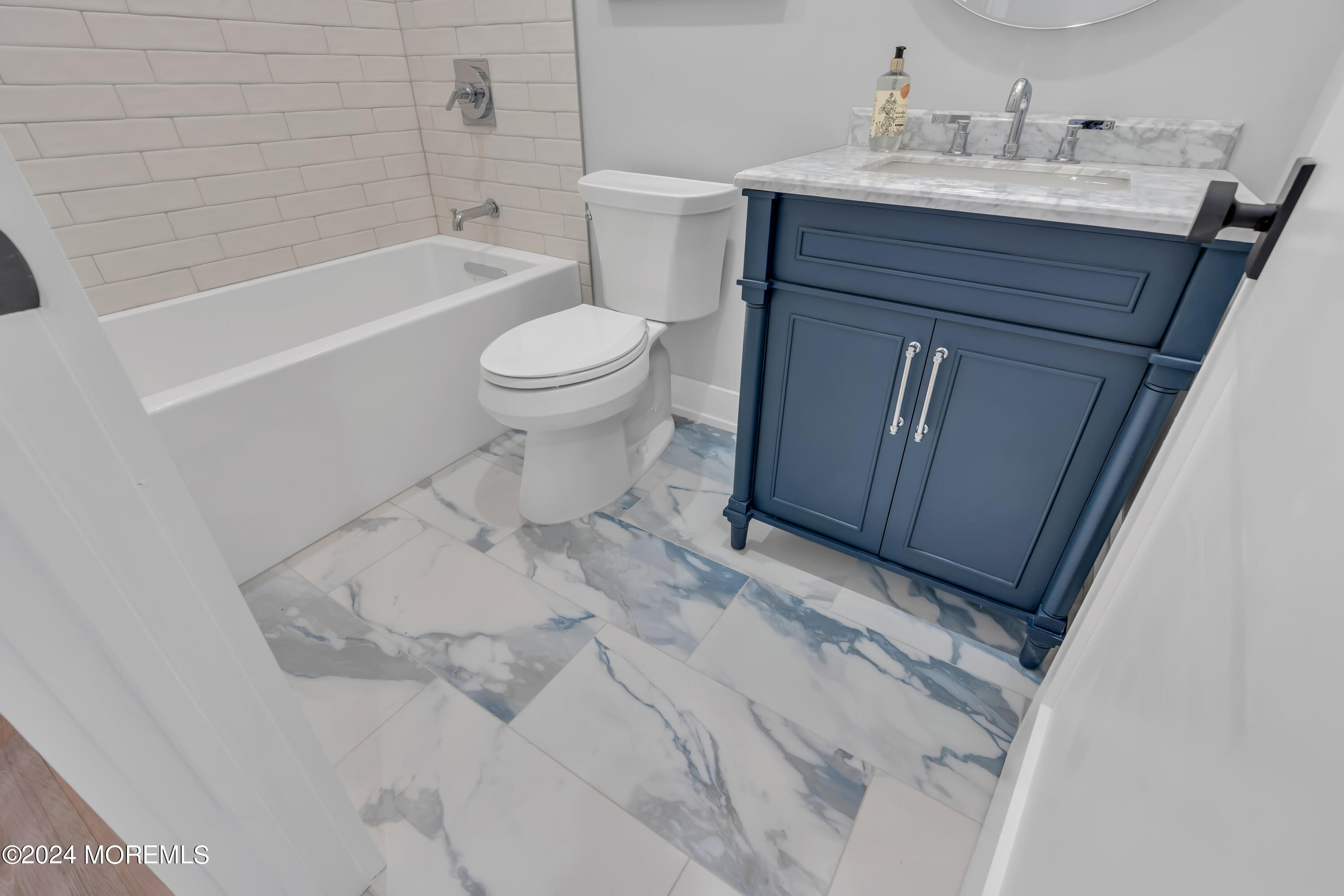 557 Ocean Road Spring Lake Heights, NJ 07762 - Photo 28 of 62 a bathroom with a sink vanity granite toilet and shower