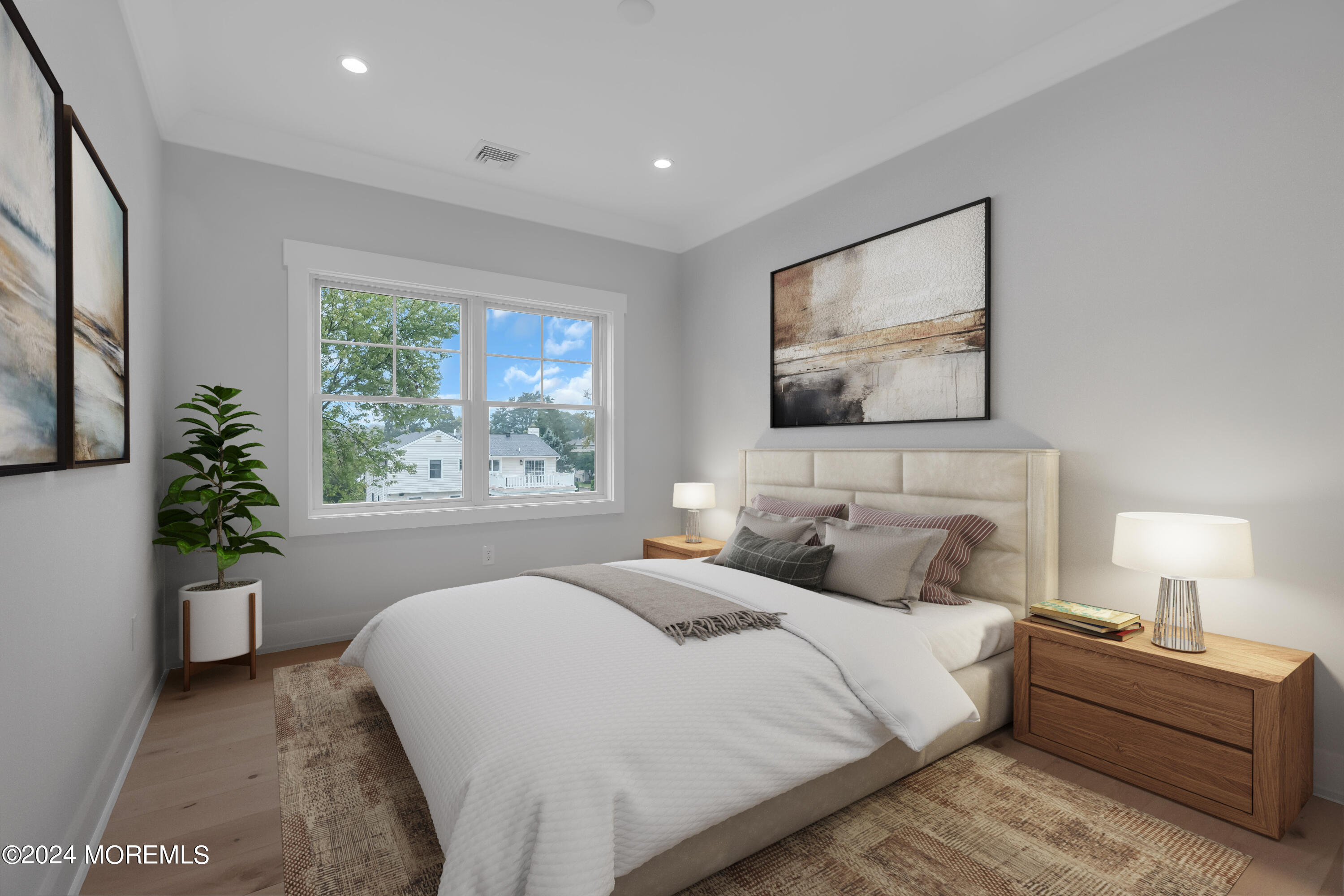 557 Ocean Road Spring Lake Heights, NJ 07762 - Photo 32 of 62 a bedroom with a large bed and a potted plant