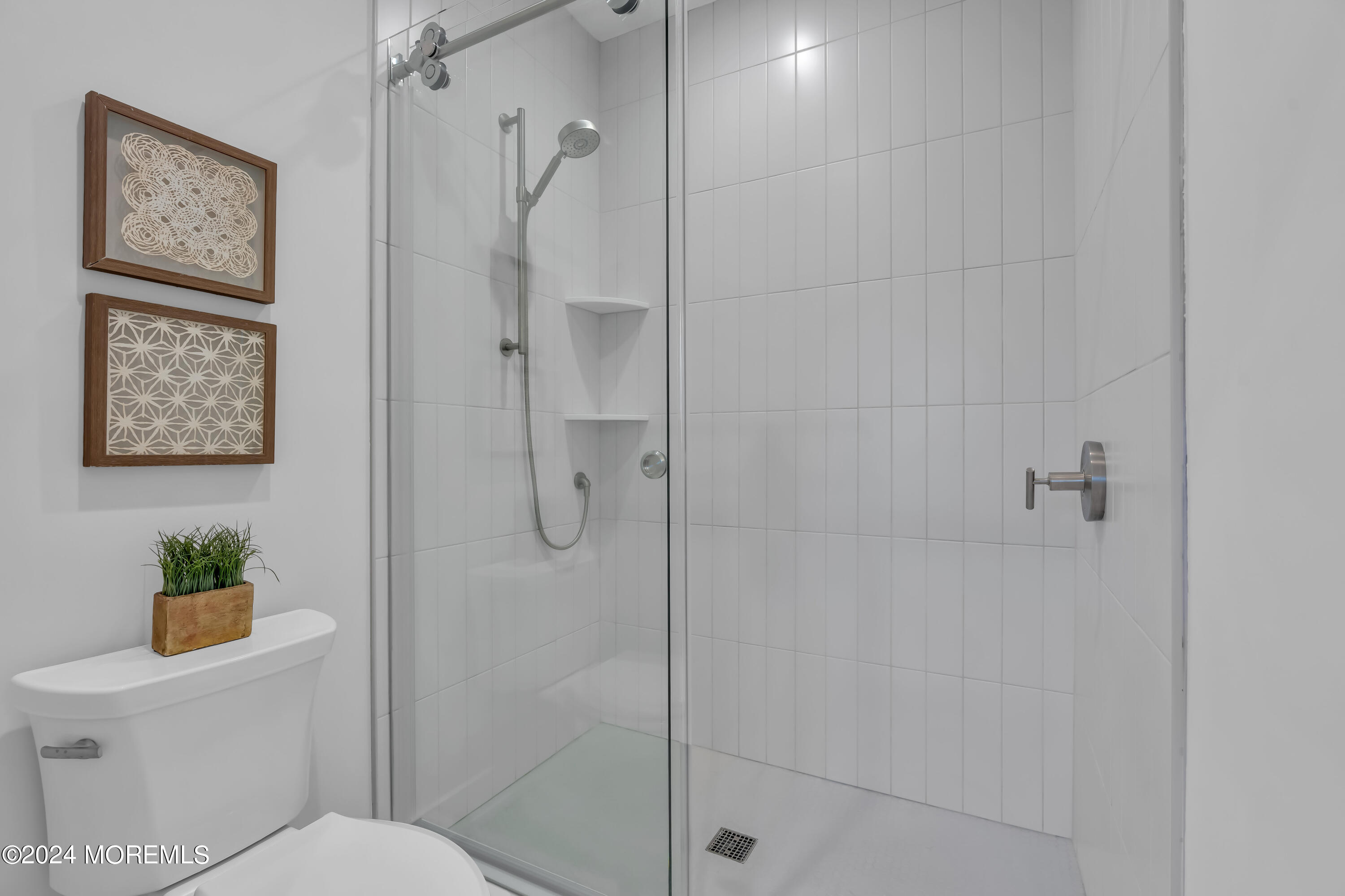 557 Ocean Road Spring Lake Heights, NJ 07762 - Photo 36 of 62 a bathroom with a shower and toilet