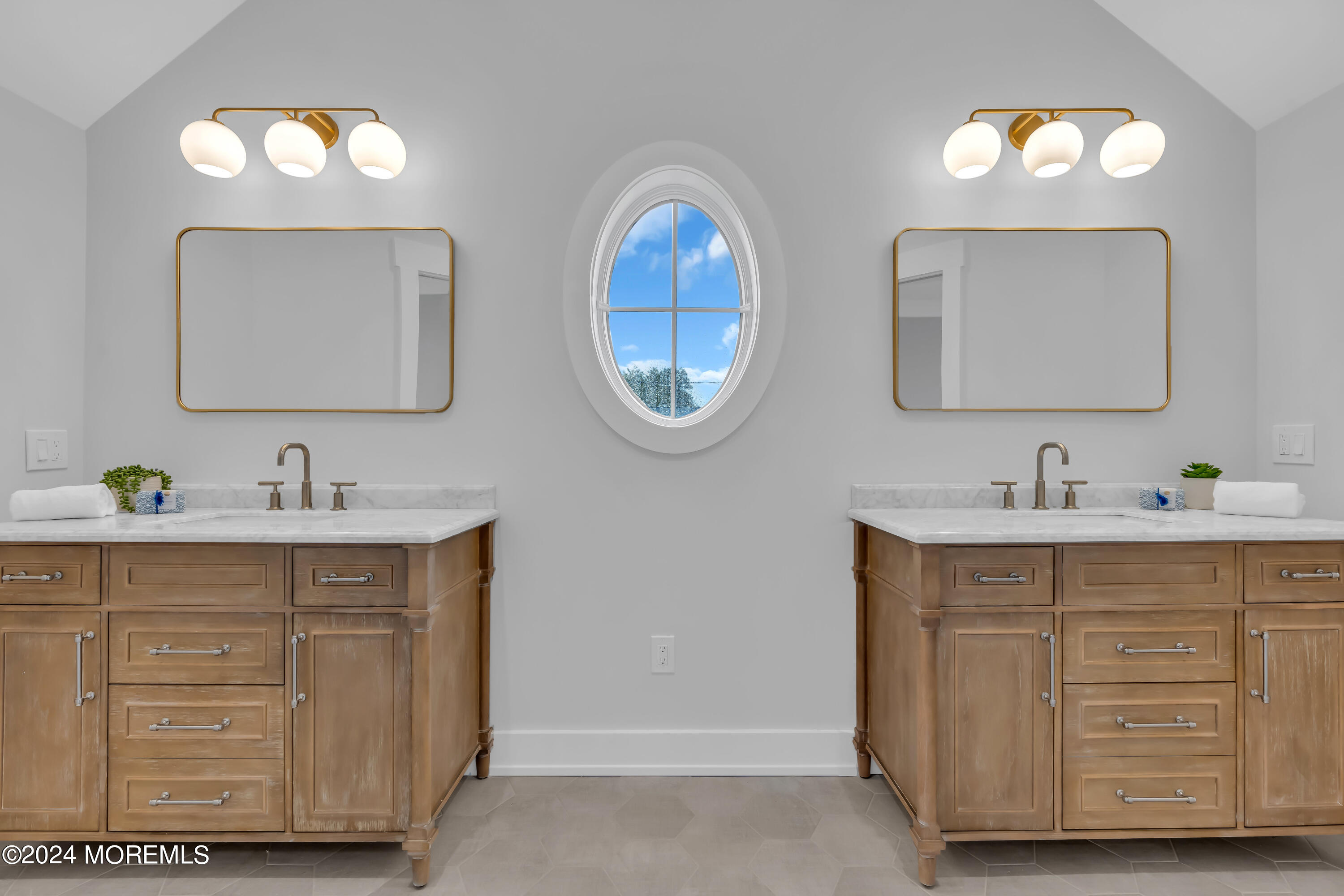 557 Ocean Road Spring Lake Heights, NJ 07762 - Photo 37 of 62 a bathroom with a double vanity sink and a mirror