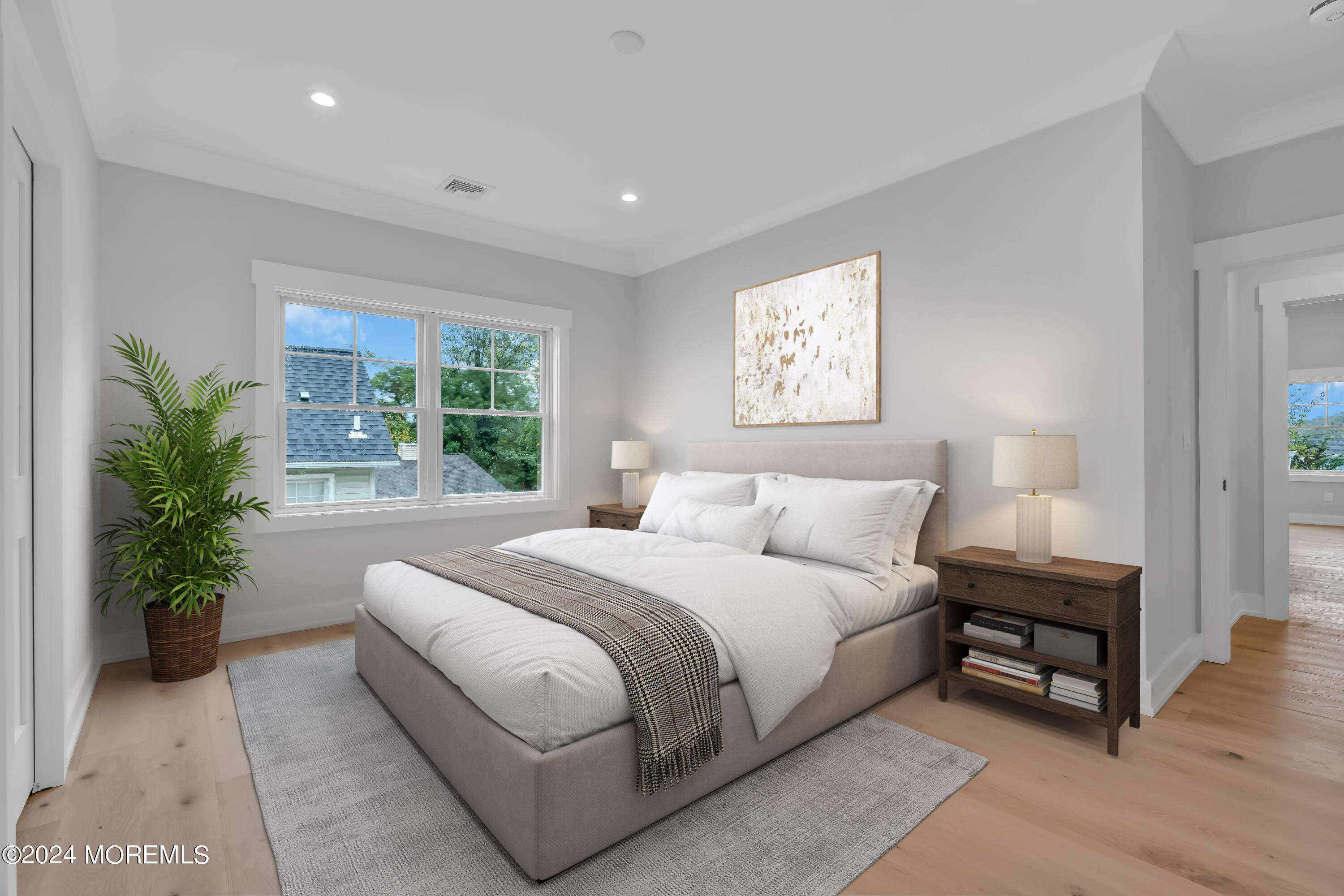 557 Ocean Road Spring Lake Heights, NJ 07762 - Photo 38 of 62 a bedroom with a large bed and a potted plant