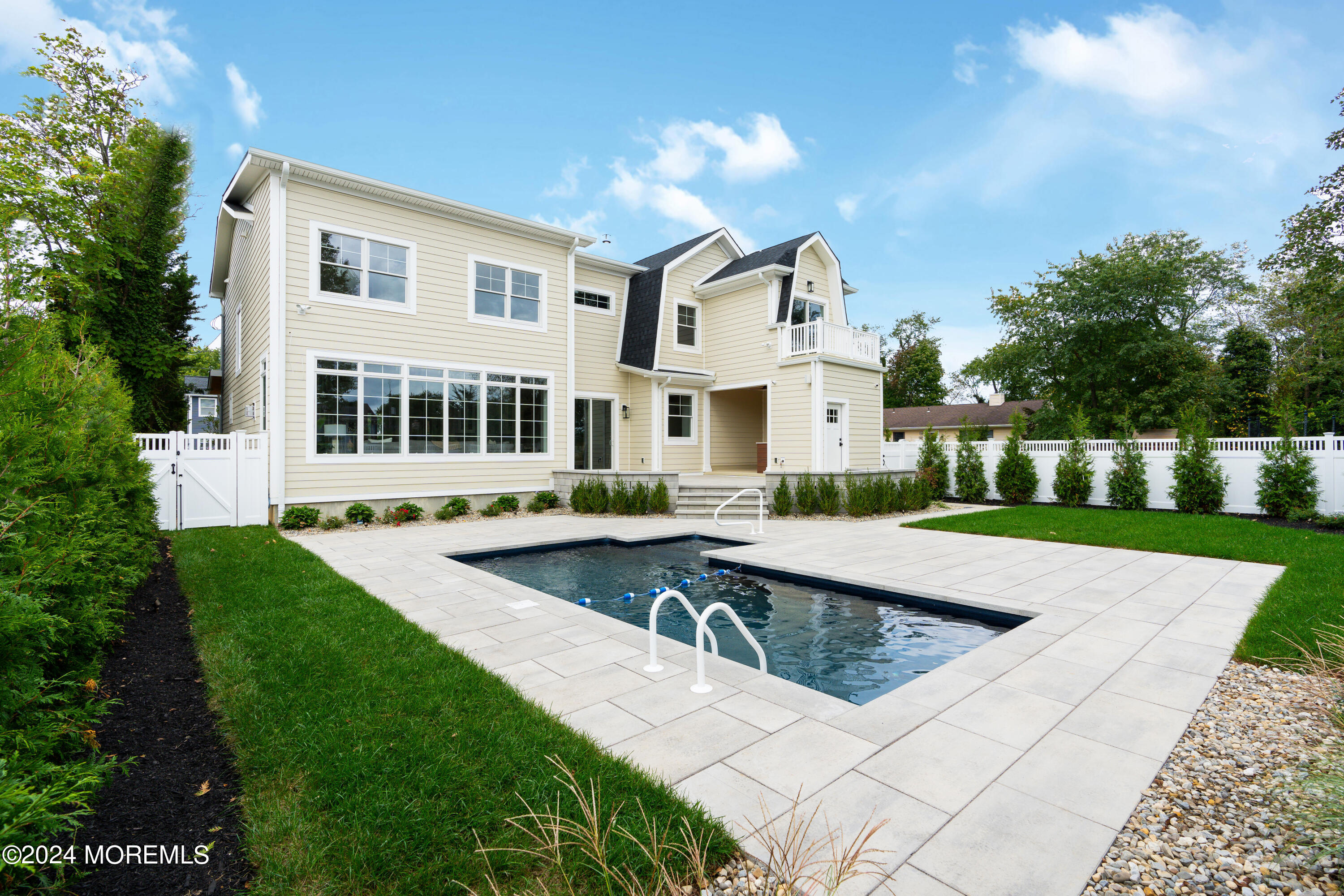 557 Ocean Road Spring Lake Heights, NJ 07762 - Photo 54 of 62 a view of a house with pool fire pit next to a yard