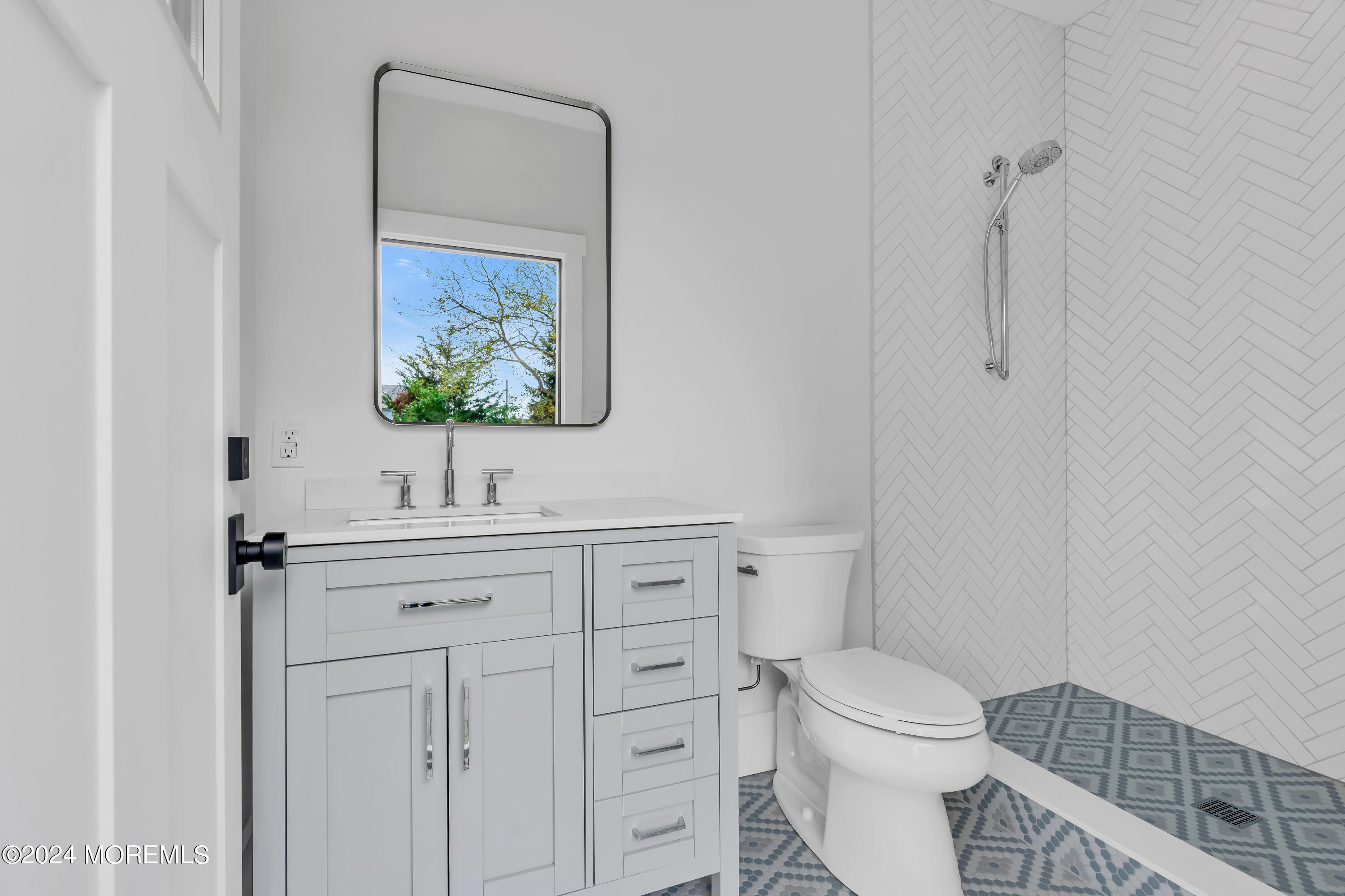 557 Ocean Road Spring Lake Heights, NJ 07762 - Photo 58 of 62 a bathroom with a toilet a sink and mirror