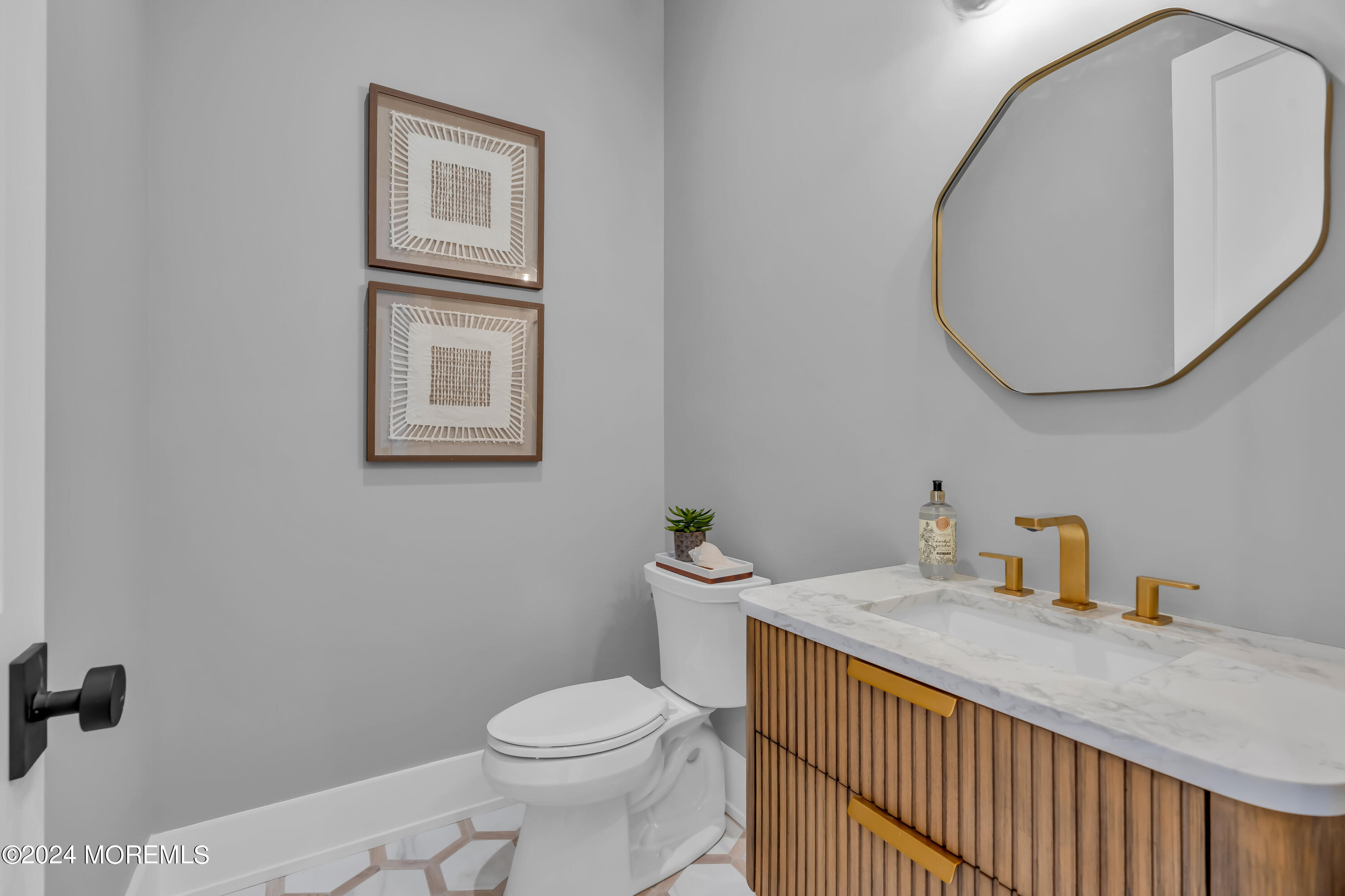 557 Ocean Road Spring Lake Heights, NJ 07762 - Photo 7 of 62 a bathroom with a sink a toilet and mirror