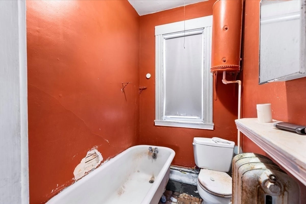 7 Liberty Street Mansfield, MA 02048 - Photo 17 of 42 a bathroom with a toilet a sink and a mirror