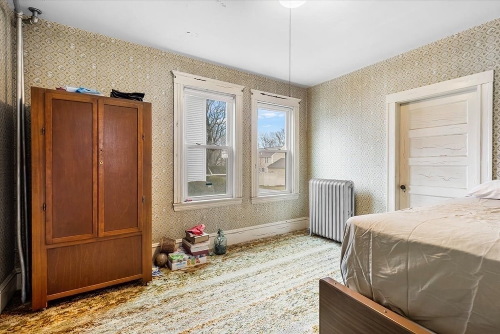 7 Liberty Street Mansfield, MA 02048 - Photo 22 of 42 a bedroom with a bed dresser and a window