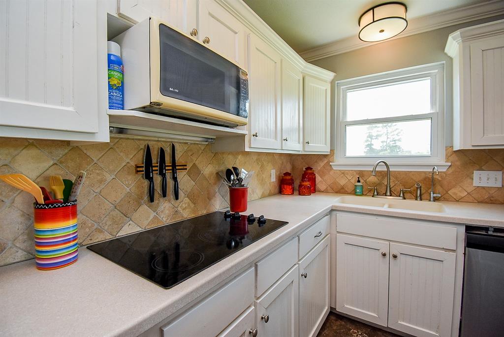 29400 Waller Gladish Road Waller, TX 77484 - Photo 11 of 39 a kitchen with stainless steel appliances granite countertop a sink dishwasher and cabinets with wooden floor