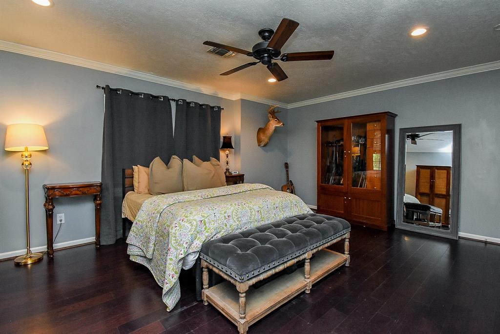 29400 Waller Gladish Road Waller, TX 77484 - Photo 15 of 39 a bed sitting in a spacious bedroom next to a lamp