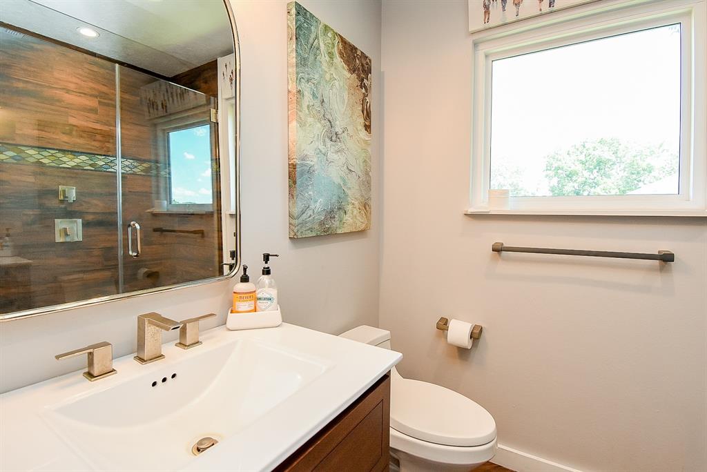 29400 Waller Gladish Road Waller, TX 77484 - Photo 23 of 39 a bathroom with a sink vanity mirror and toilet