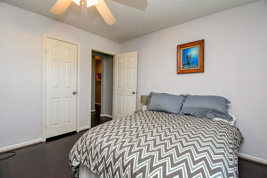 29400 Waller Gladish Road Waller, TX 77484 - Photo 26 of 39 a bedroom with a large bed and a chandelier