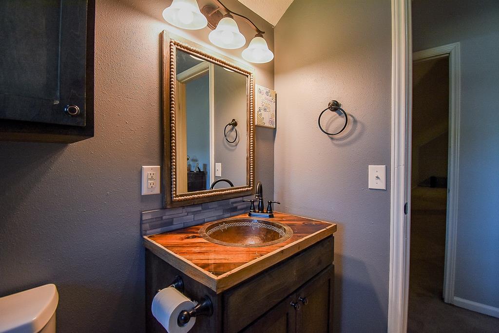 29400 Waller Gladish Road Waller, TX 77484 - Photo 29 of 39 a bathroom with a sink a mirror and a toilet