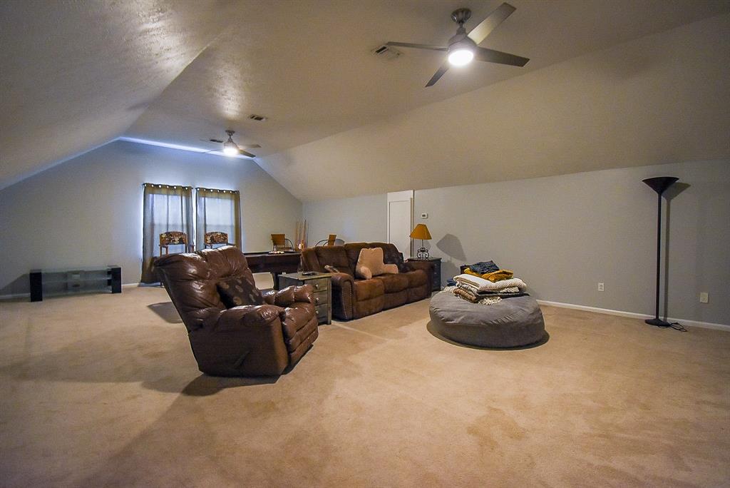 29400 Waller Gladish Road Waller, TX 77484 - Photo 30 of 39 a living room with furniture a lamp and a ceiling fan