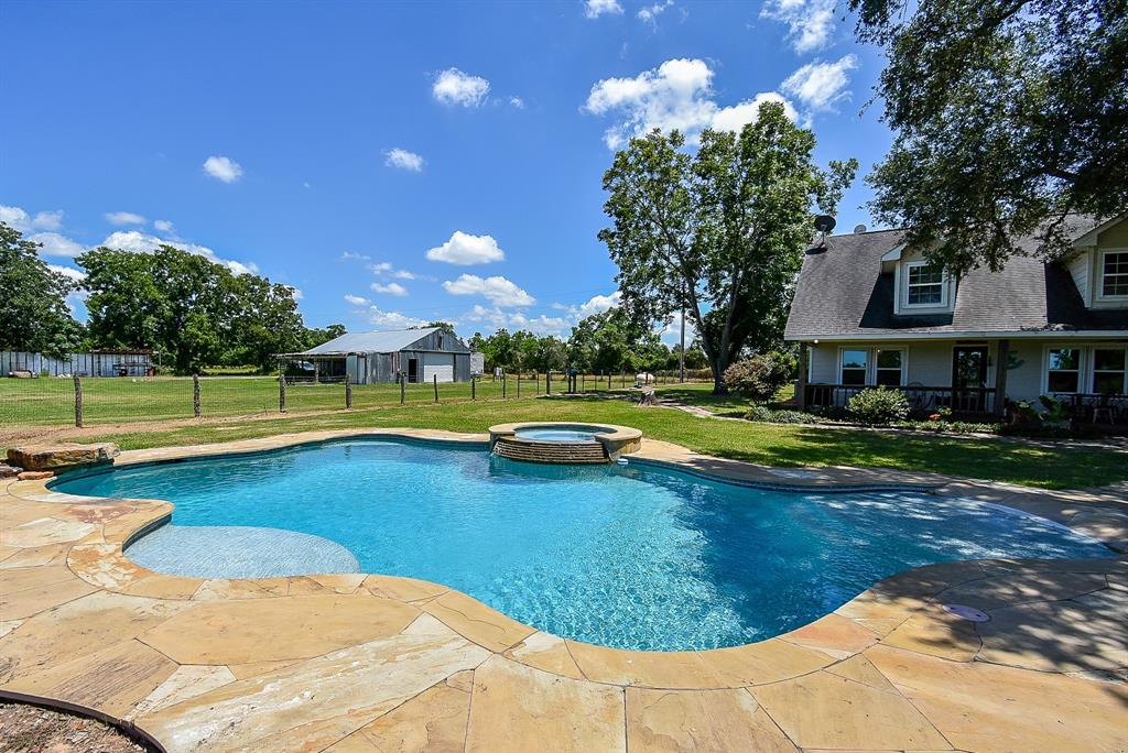 29400 Waller Gladish Road Waller, TX 77484 - Photo 34 of 39 a view of a swimming pool with an outdoor space and seating area