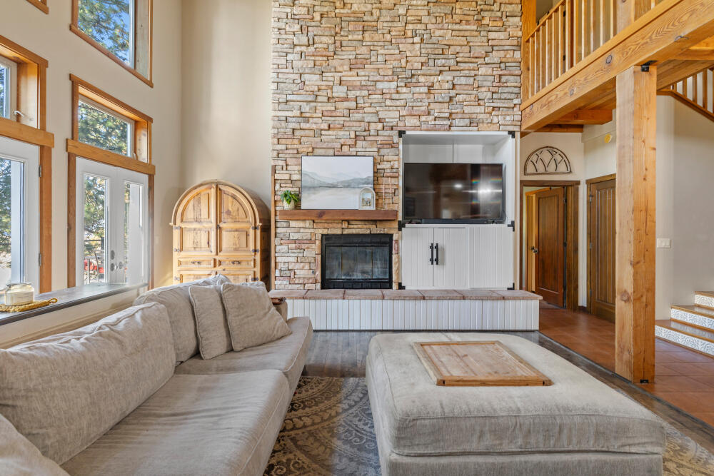 11750 Merganser Road Klamath Falls, OR 97601 - Photo 11 of 66 a living room with furniture a flat screen tv and a fireplace