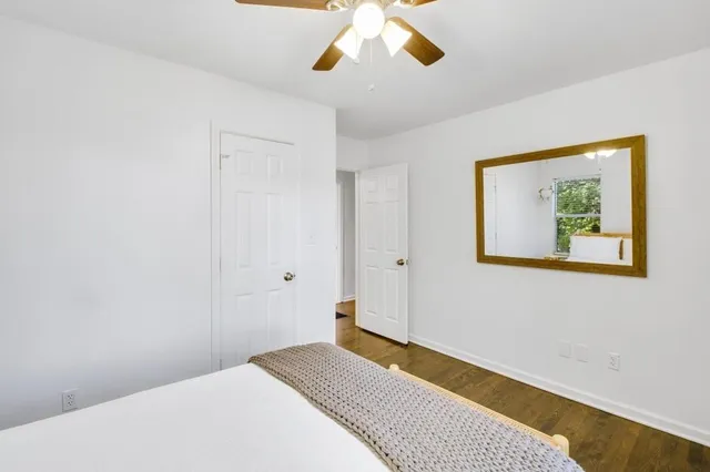 a bedroom with a bed and a painting on the wall