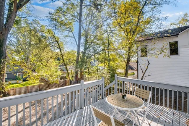 a view of a chair and tables in the balcony