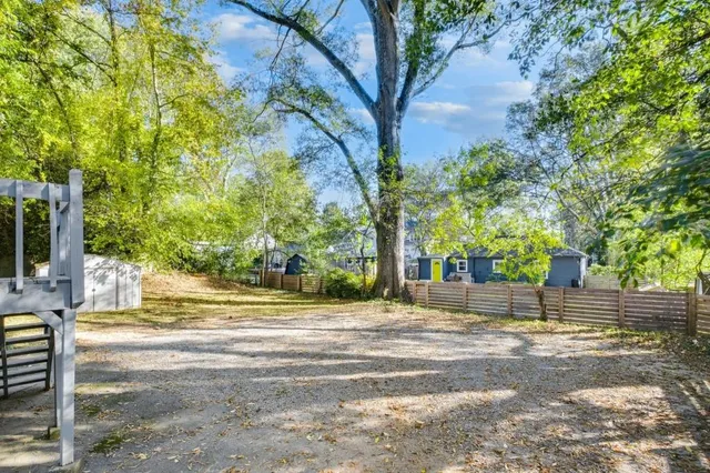 a view of a yard with large trees