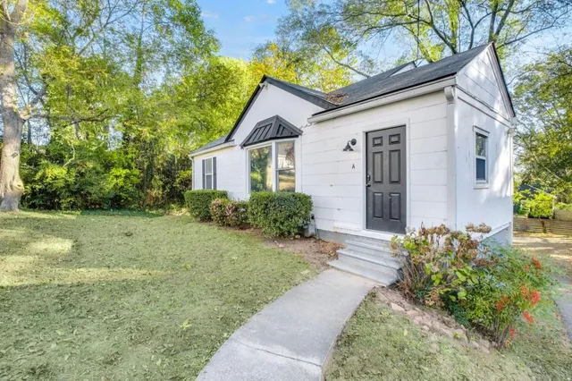 a front view of a house with garden
