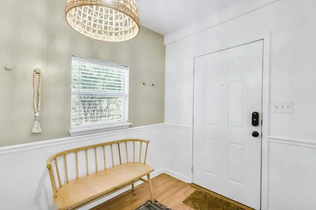 a view of a room with wooden floor and windows