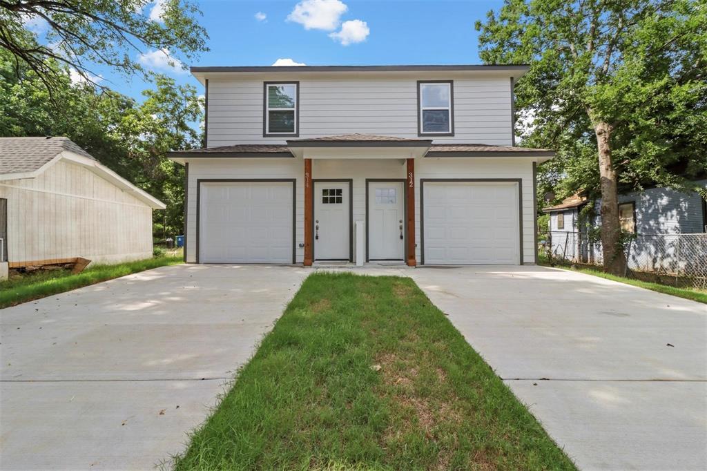 312 East Shepherd Street, Unit 312 Denison, TX 75021 - Photo 1 of 15 a front view of a house with a garden and yard