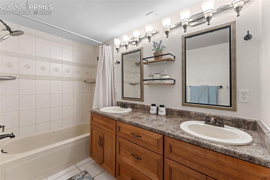 1851 Buttercup Road Elizabeth, CO 80107 - Photo 28 of 47 a bathroom with a granite countertop sink mirror and a bathtub