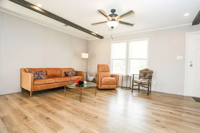 a kitchen with a refrigerator a stove cabinets and a dining table