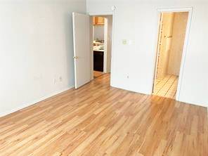 806 West 24th Street, Unit 229 Austin, TX 78705 - Photo 1 of 23 an empty room with wooden floor and a bathroom