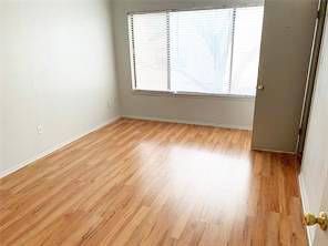 806 West 24th Street, Unit 229 Austin, TX 78705 - Photo 17 of 23 an empty room with wooden floor and windows