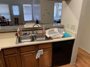 806 West 24th Street, Unit 229 Austin, TX 78705 - Photo 10 of 23 a sink with a cabinets and wooden floor